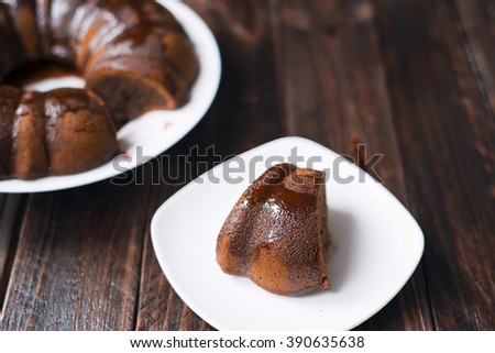 A piece of Bundt cake with chocolate icing.