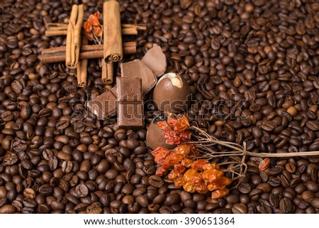 Coffee beans background with  cinnamon, and chocolate
