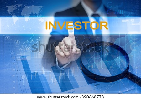 Businessman hand touching INVESTOR button on virtual screen