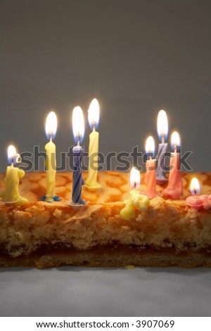 Burning color candles on a celebratory pie