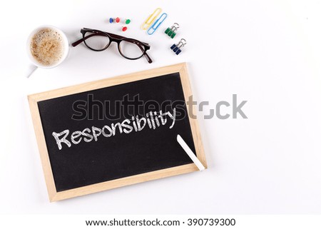 Responsibility word on chalkboard with coffee cup and eyeglasses, view from above
