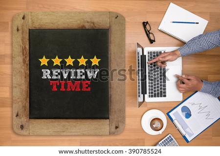 Businessman working at office desk and using computer and objects on the right, coffee,  top view, Review Time words