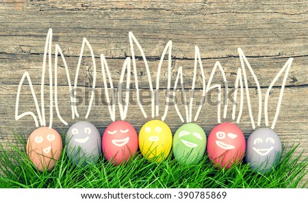 Colorful easter eggs in green grass. Funny holidays decoration. Vintage style toned picture