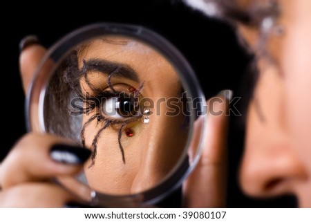 Spider makeup on eye in mirror