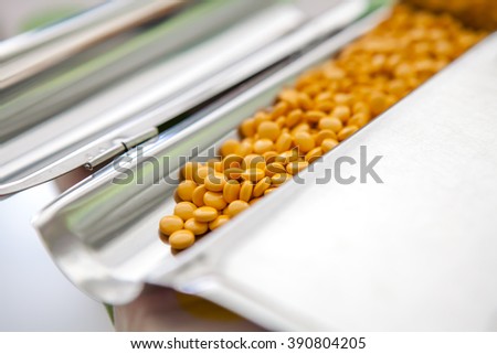 Yellow Pills on stainless steel counting tray