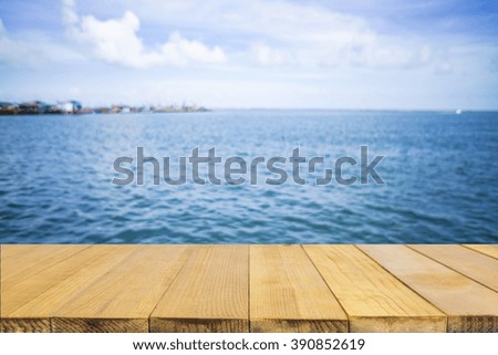 Empty top of wooden table or counter and view of tropical beach. For product display
