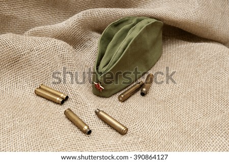 Army cap with a star and cartridges on the background fabric.