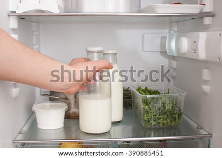 put milk in fridge Royalty-Free Stock Photo #390885451