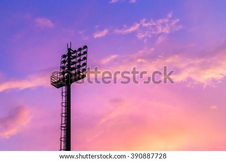 Silhouette of the stadium light tower with beautiful sunset sky background