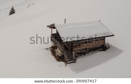 A view of the huts in snow covered landscape in the mountains in Seiser alm