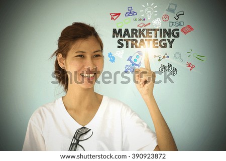 young woman smiling and hand pointing at MARKETING STRATEGY concept , business concept , business idea , business marketing , strategy concept