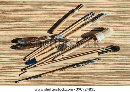 Paint brushes on an oil canvas