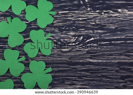 Fabric green clover leaves on wooden background. 