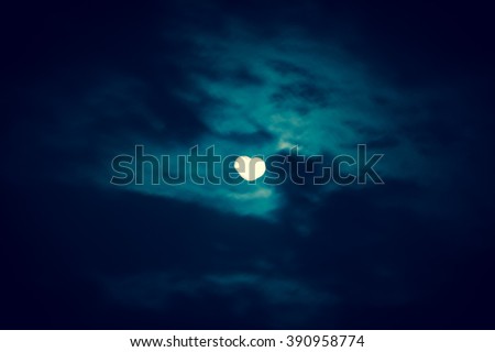 Blurry abstract heart moon background. Blurred moon in shape of the heart. Toned photo.