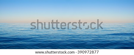 Panorama of sea waves on the background of dawn Royalty-Free Stock Photo #390972877