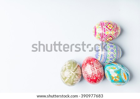 colorful shiny easter eggs on blue background Royalty-Free Stock Photo #390977683