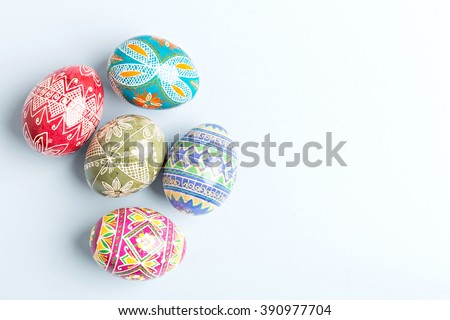 colorful shiny easter eggs on blue background Royalty-Free Stock Photo #390977704