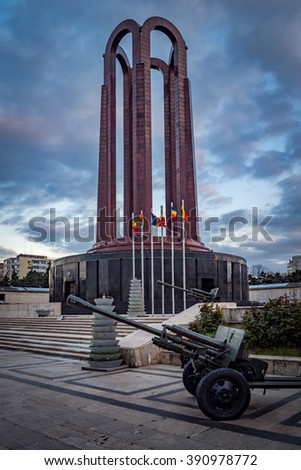 The Mausoleum Of Romanian Heroes (sometimes called the Tomb of the Unknown soldier) was built in 1963 and it is located in Carol Park in Bucharest, Romania with a artillery cannon in the foreground