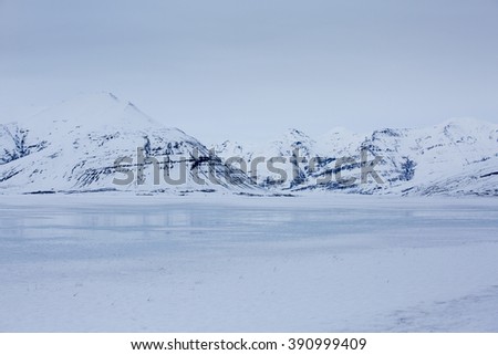 Snow covered lava fields with glacier in background, Vatnajokull national park, Southern Iceland
