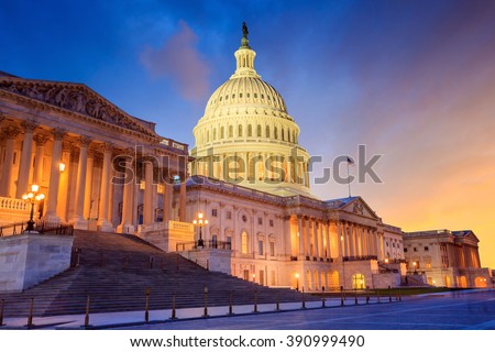 The United States Capitol building with the dome lit up at night.  Royalty-Free Stock Photo #390999490
