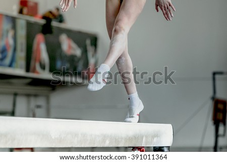 girl gymnast athlete during exercise on balance beam in gymnastics competitions