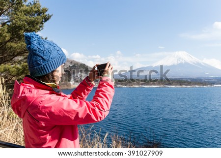 Woman take photo on mountain fuji