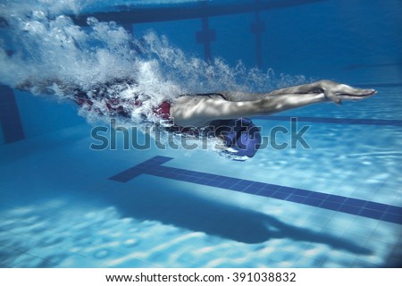 swimmer jump from platform jumping a swimming pool.Underwater photo