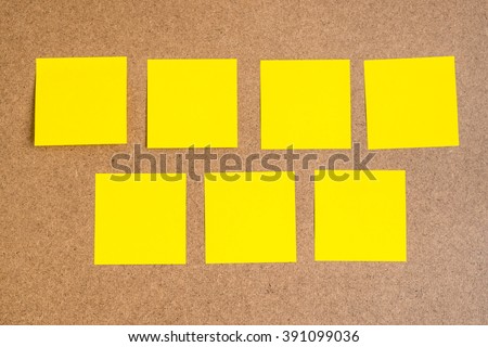 Seven blank yellow sticky notes on brown wood board - concept of business work, education, idea from team