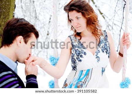Loving couple in the winter forest