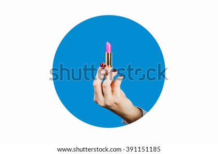 Bright pink lipstick in the hands. on a blue background. fashionable accessories icon. cosmetics. the concept of beauty. Close up of lipstick, red nails, blue circle, White background, isolated