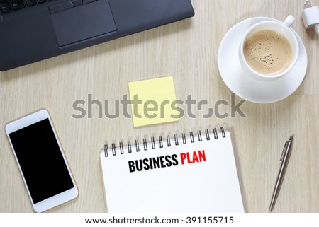 Top view of Business plan on desk  with computer, smartphone,stationery and coffee cup