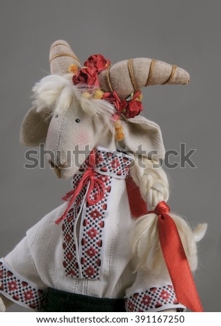 textile toy - goat on the grey background