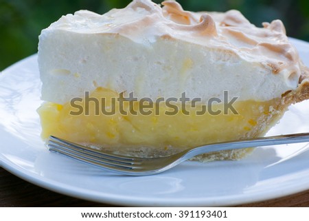 Closeup of slice of lemon meringue pie on plate