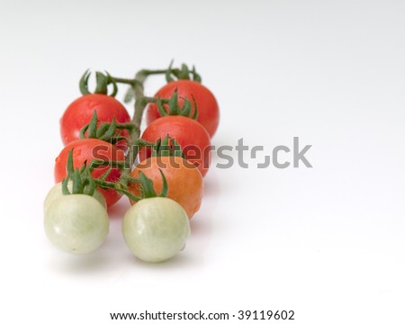 Cluster of cherry  tomatoes on the white isolated background
