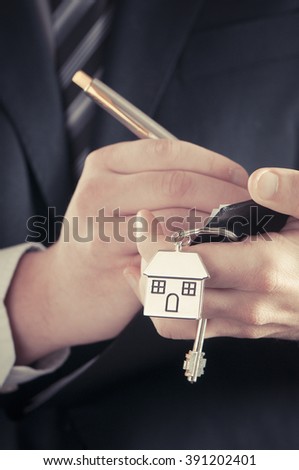 Real estate agent handing over house keys 