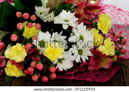 Beautiful bouquet of colorful flowers on a dark wooden table