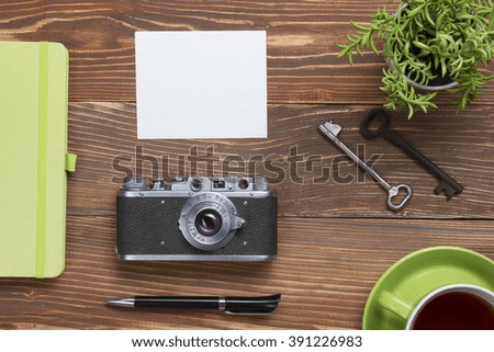 Travel, vacation concept. Camera and supplies on office wooden desk table. Top view with copy space for text