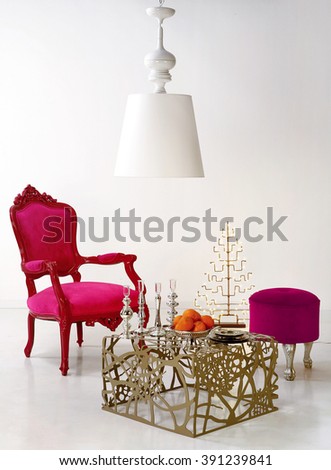 pink classical armchair and white vintage chandelier on white background; still life