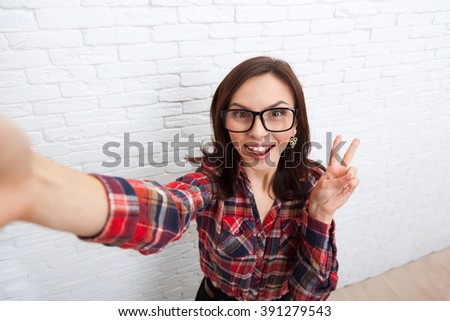 Girl Taking Selfie Smart Phone Photo Camera Woman Posing Over White Brick Office Wall