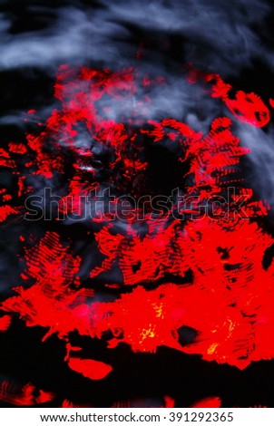 Abstract water like background. Red lights reflected on the water. Water splash on black background. Intentional motion blur.