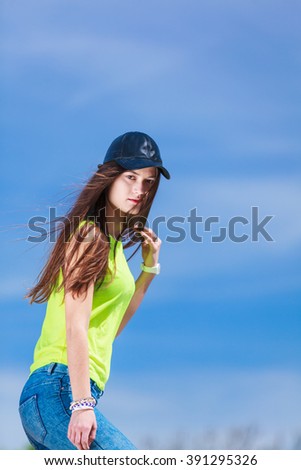 Portrait of pretty casual teenager girl in cap outdoor. Urban street fashion.