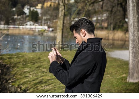 Handsome young man on a lake in a sunny day