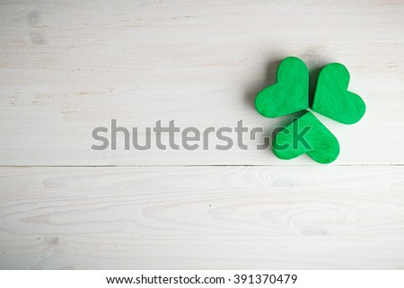 Green shamrock clovers on white wooden background. Background for St. Patrick's Day celebration