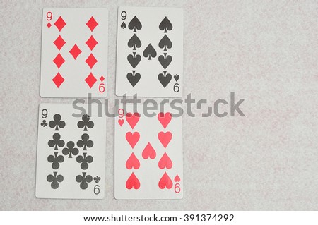 The different suit of the number 9 cards in a deck of cards displayed on a white background