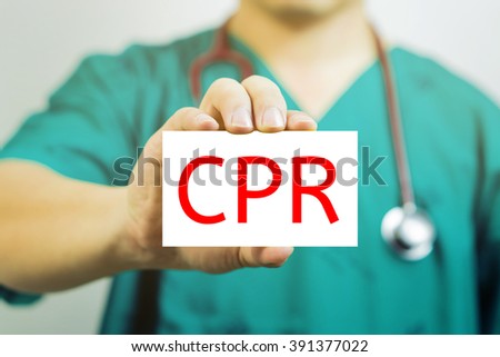 Doctor holding a  business card with capital lettering   CPR in hand, Medical and healthcare  concept, medicals support and service ,Selective focus.vintage tone.