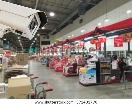The CCTV Security Camera operating in counter service cashier at supermarket store blur background.