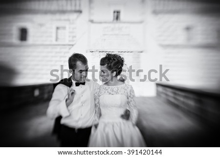 Beautiful romantic couple walking in old town b&w