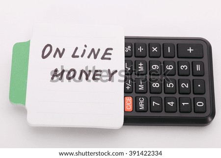 Concept write - On line money. Sign lays on calculator