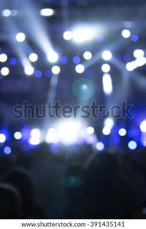 De-focused / blurred concert crowd enjoying the music.
