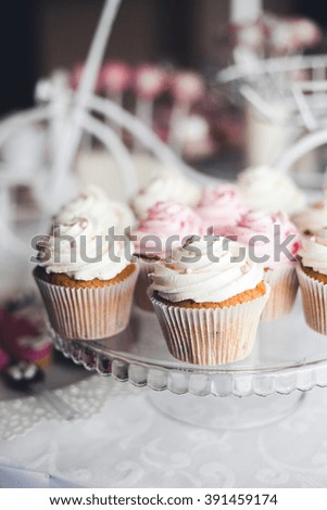 Candy table for wedding, birthday or holiday. Light picture with cupcakes with creme.